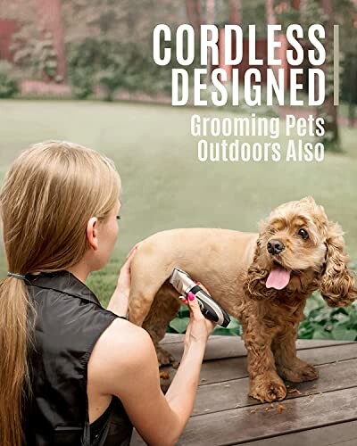 Woman grooming a dog outdoors with a cordless device.