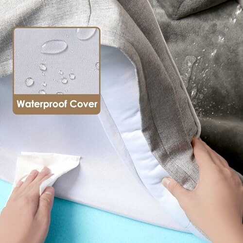 Hands lifting a waterproof mattress cover with water droplets on the surface.